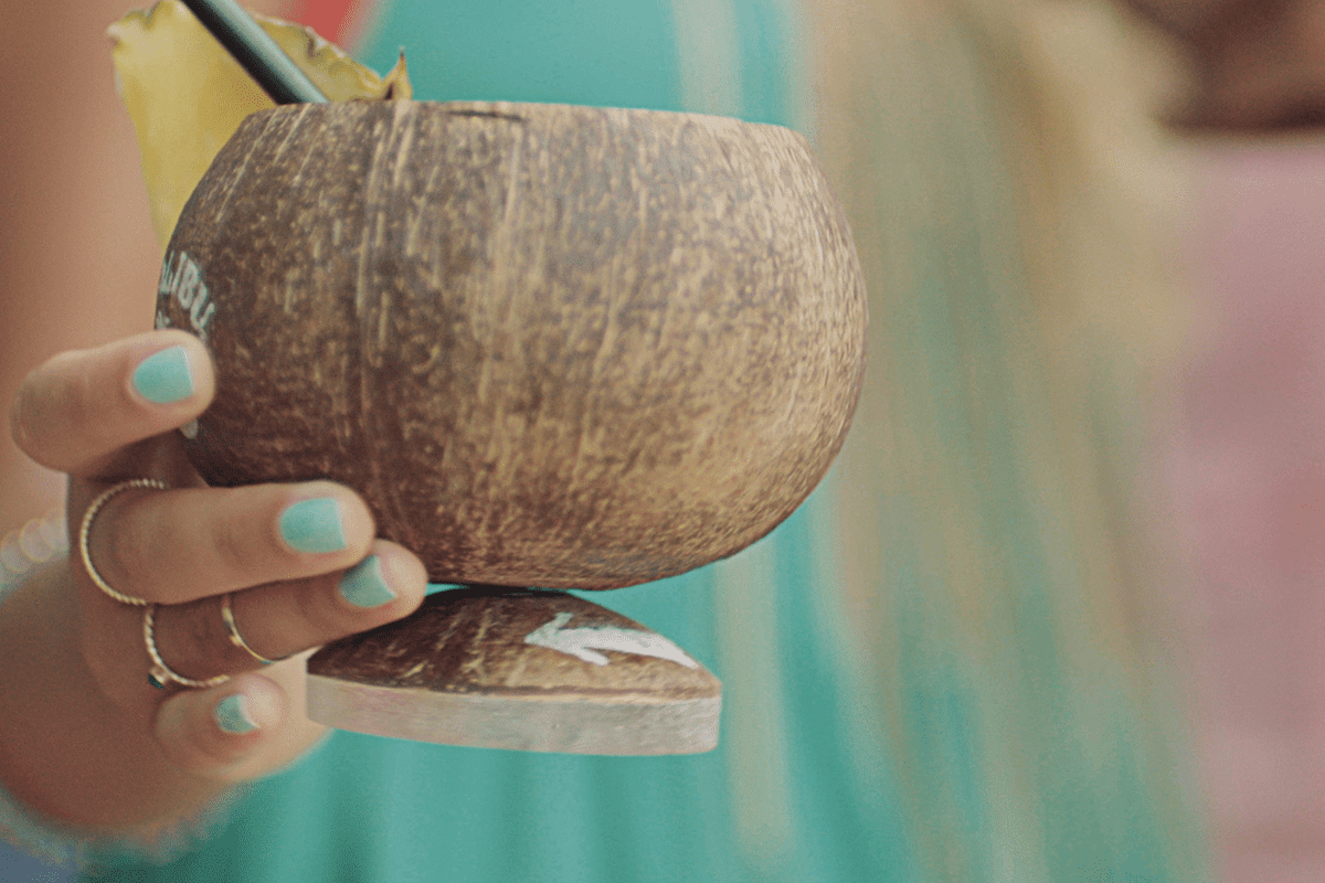 Connected coconut vessels twist at the base to order a Malibu refill