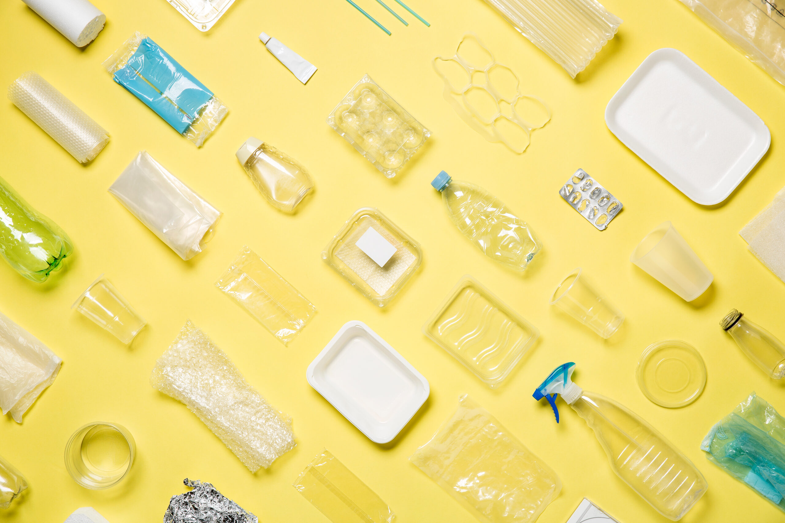 Different,Types,Of,Used,Plastic,Packaging,Arranged,On,A,Yellow