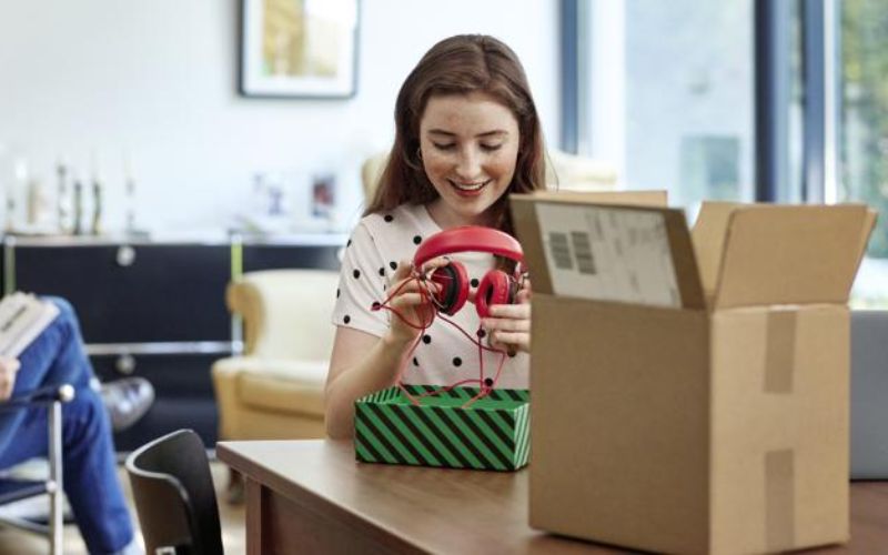 woman-looking-at-unpacked-headphones.web.800.392 copy