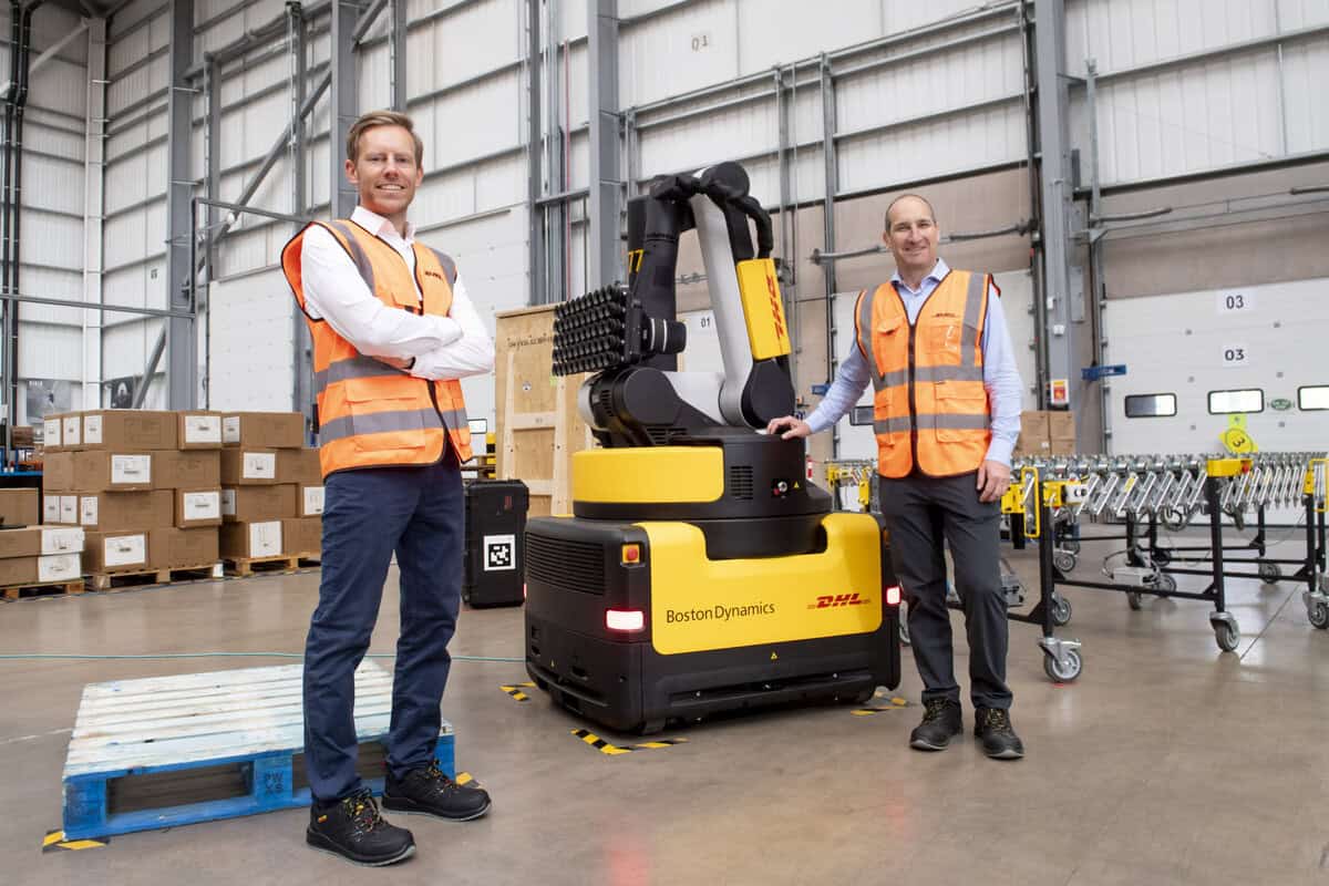 DHL executives Saul Resnick and Tim Tetzlaff with a new warehouse robot