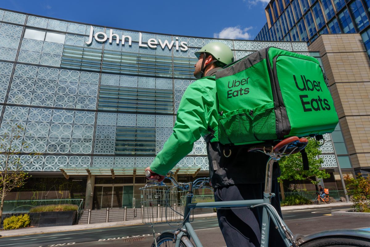 Uber Eat delivery driver in front of John Lewis store